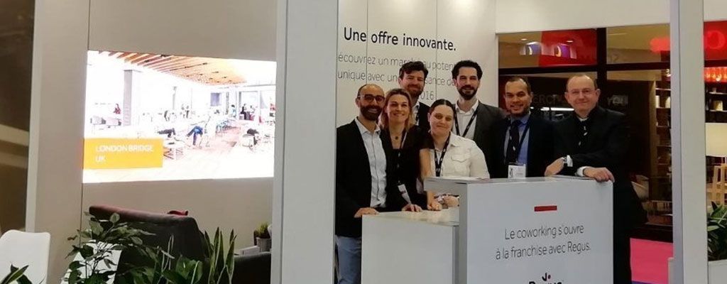 A group of men and women gathered at the Regus Paris Expo
